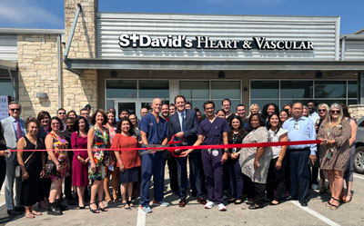Ribbon cutting event for new Kyle location. The team and staff members in front of St. David's Heart and Vascular building.