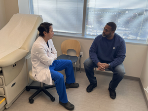 Carl Hall speaking with a doctor