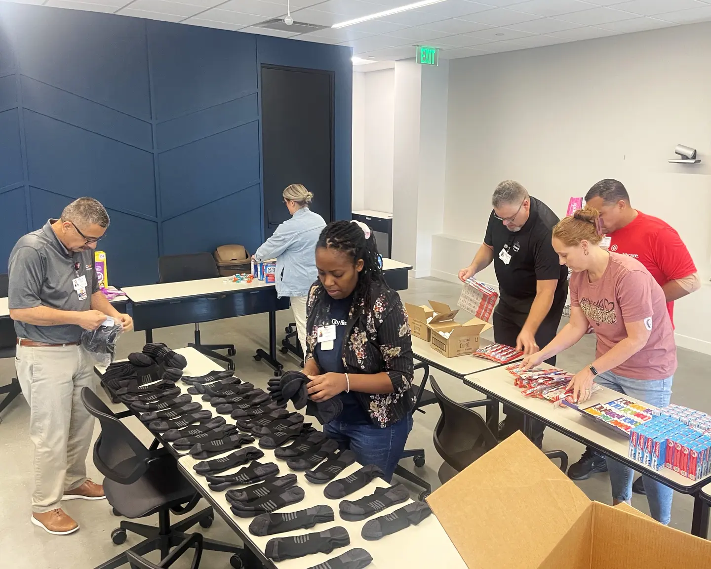 Care packages being created with socks and toothpaste.