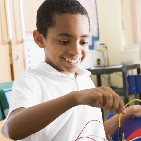 A child smiles while playing with with a toy.