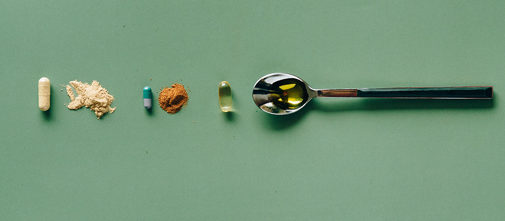 Three different vitamins, showing the capsules they come in with their powder and liquid contents next to the capsule.