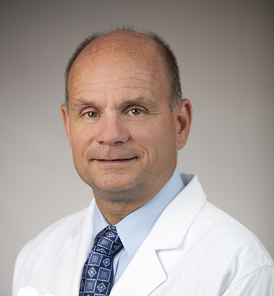 Chief of Trauma Services at Memorial Health Dr. James Dunne wearing a physician's jacket.