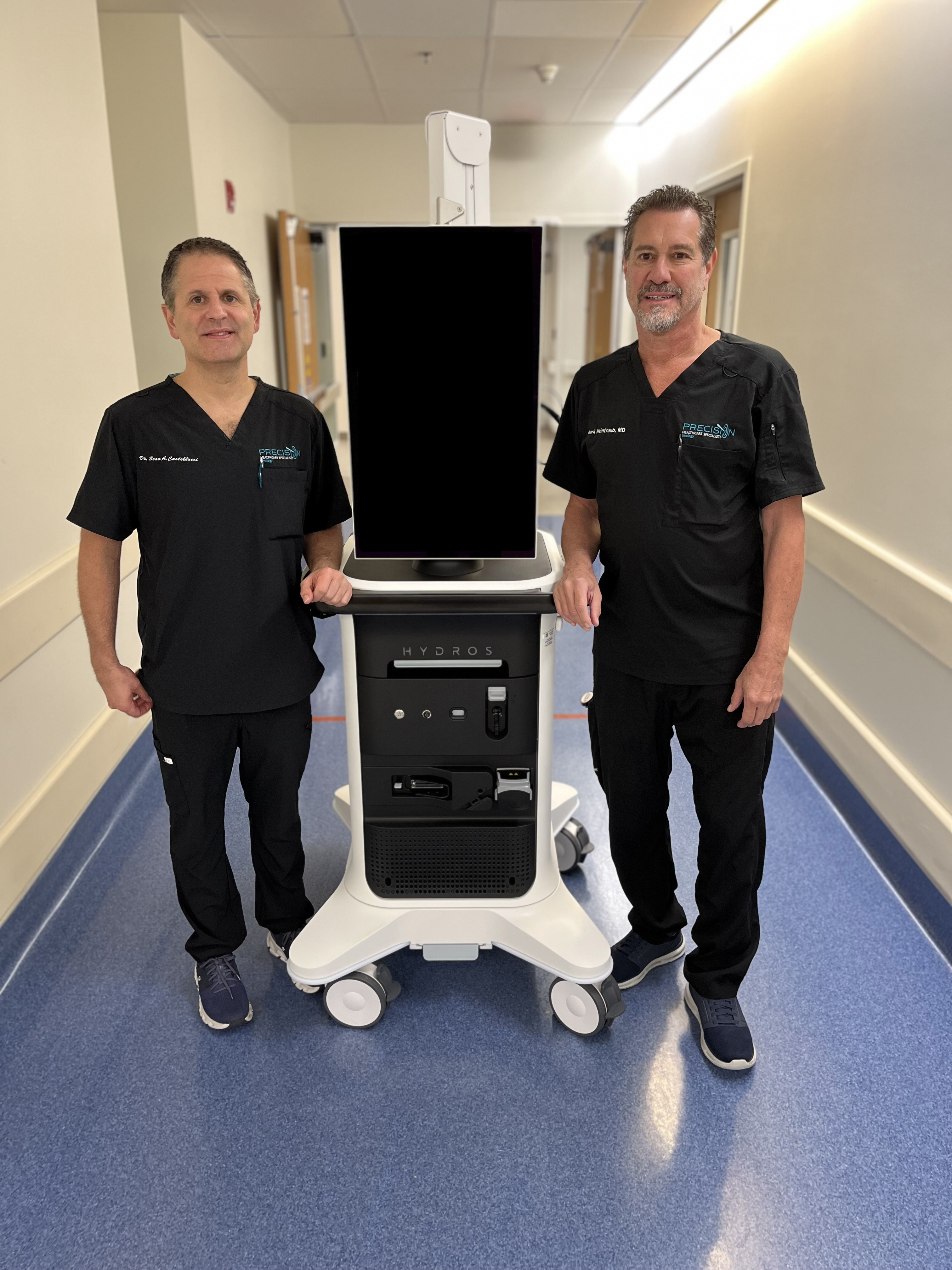 Dr. Sean Castellucci (L) and Dr. Mark Weintrub (R), pictured with the Hydros robotic technology, are now offering aquablation therapy at HCA Florida Blake Hospital to treat enlarged prostate.