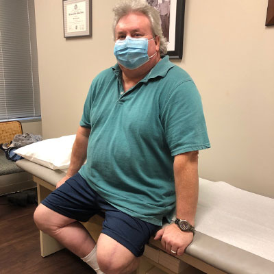 William Thompson sitting on a doctor bench.