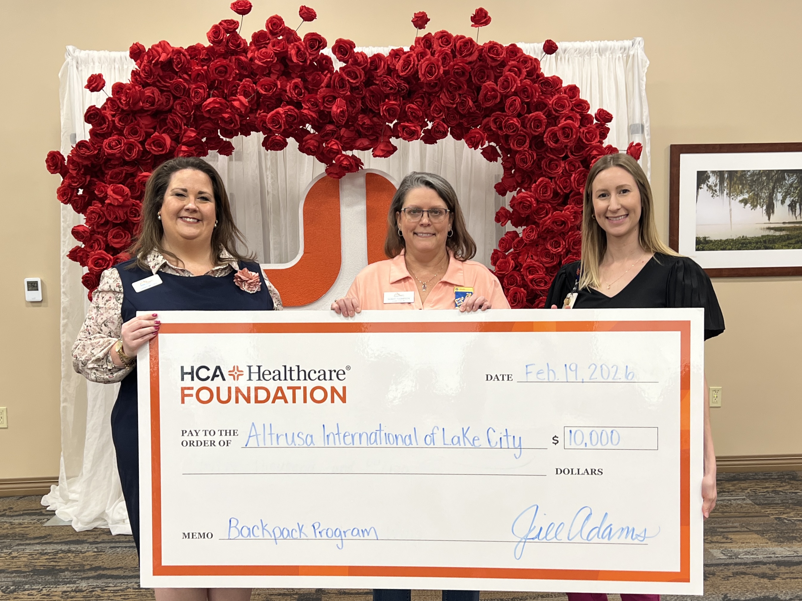 Ginny McCall (left), Sandy Thompson (center), and Lindsey Covington (right) present a $10,000 check from HCA Florida Lake City Hospital to Altrusa International of Lake City, Florida in support of its backpack program, which provides food to local students in need.