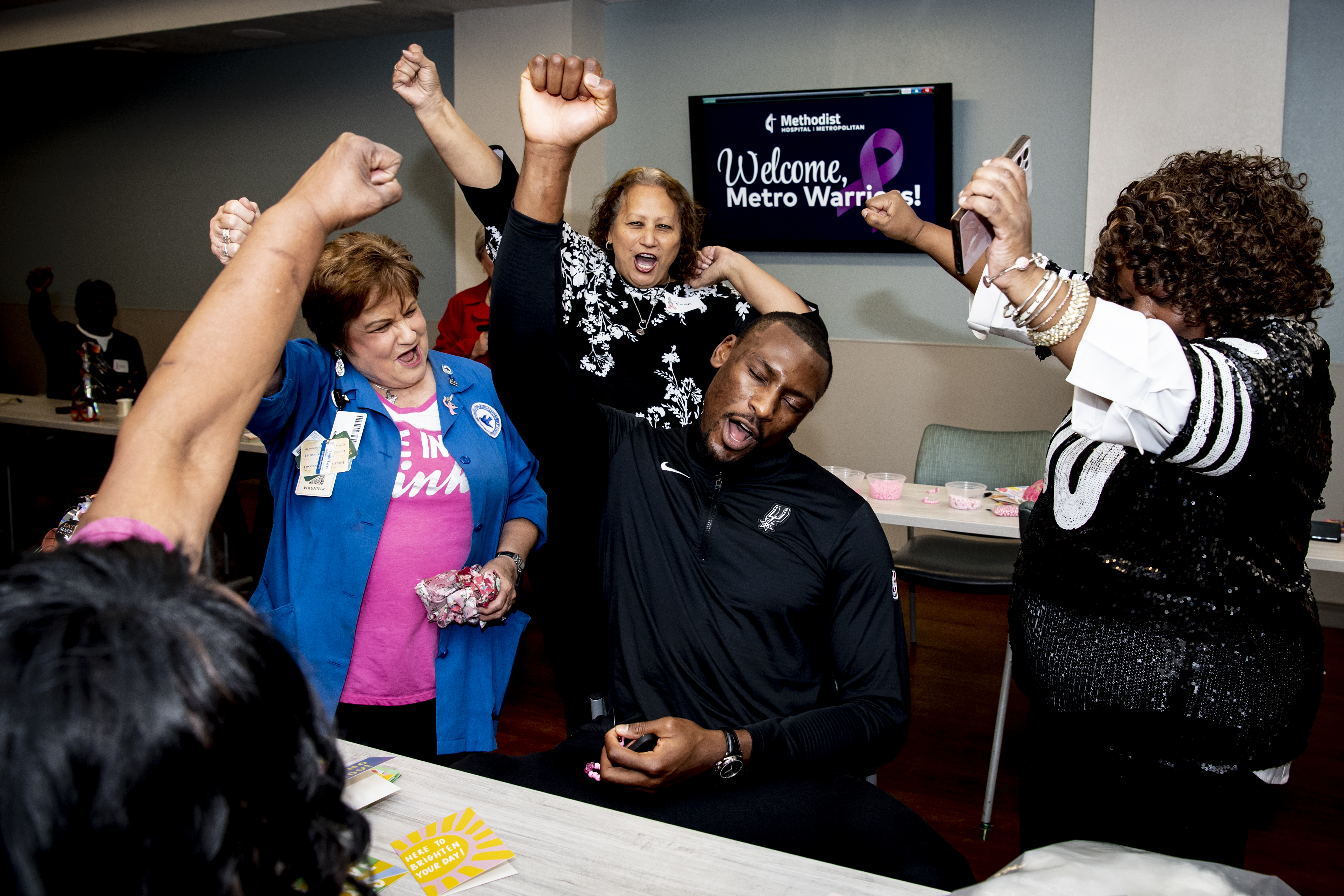 Bismack Biyombo cheers with a group of breast cancer survivors at Methodist Hospital Metropolitan.