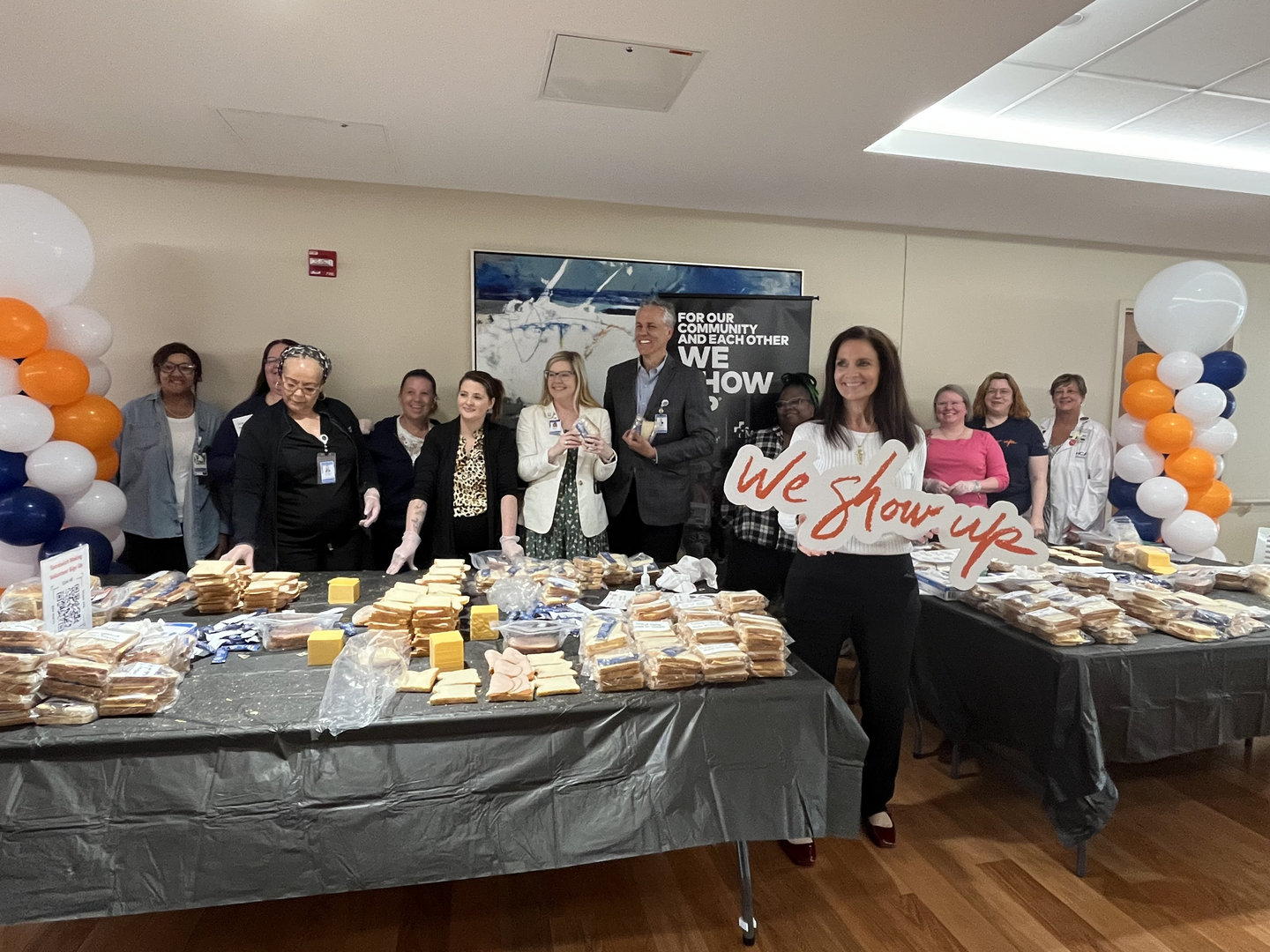 A group of volunteers pose with items donated.
