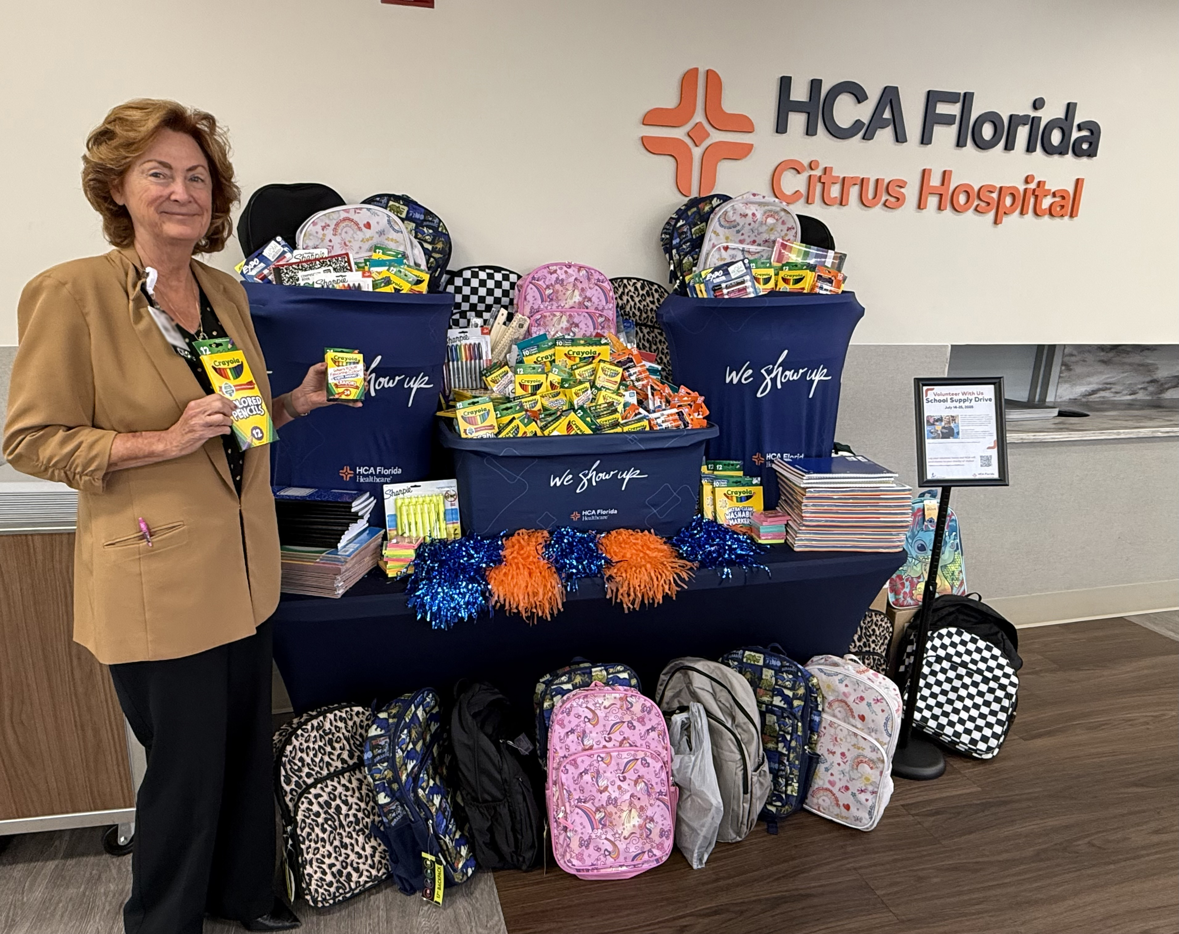 HCA Florida Citrus Hospital CEO Lisa Nummi with some of the hospital's donated school supplies. 