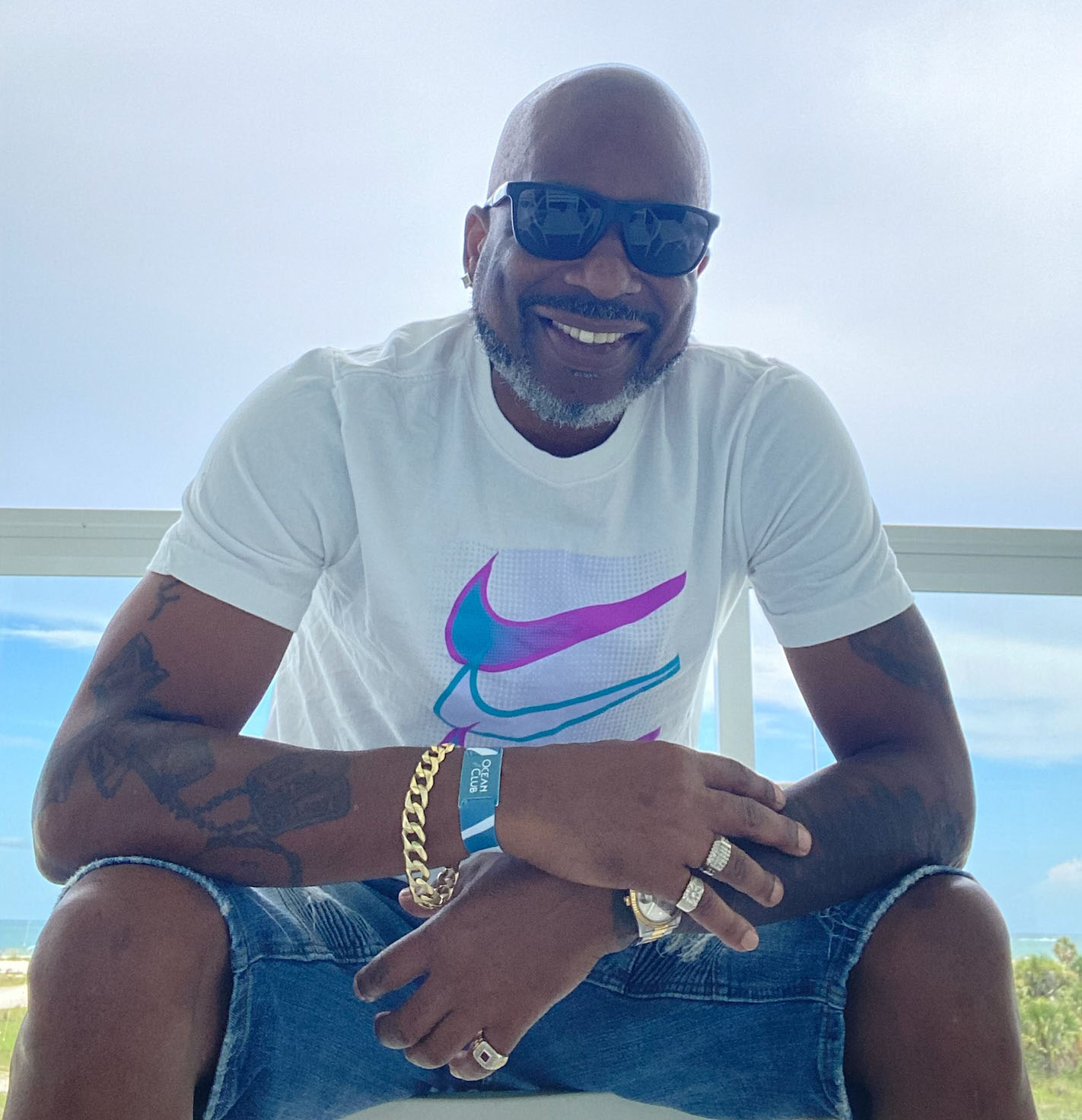 Bryan Booker sitting outside wearing sunglasses.