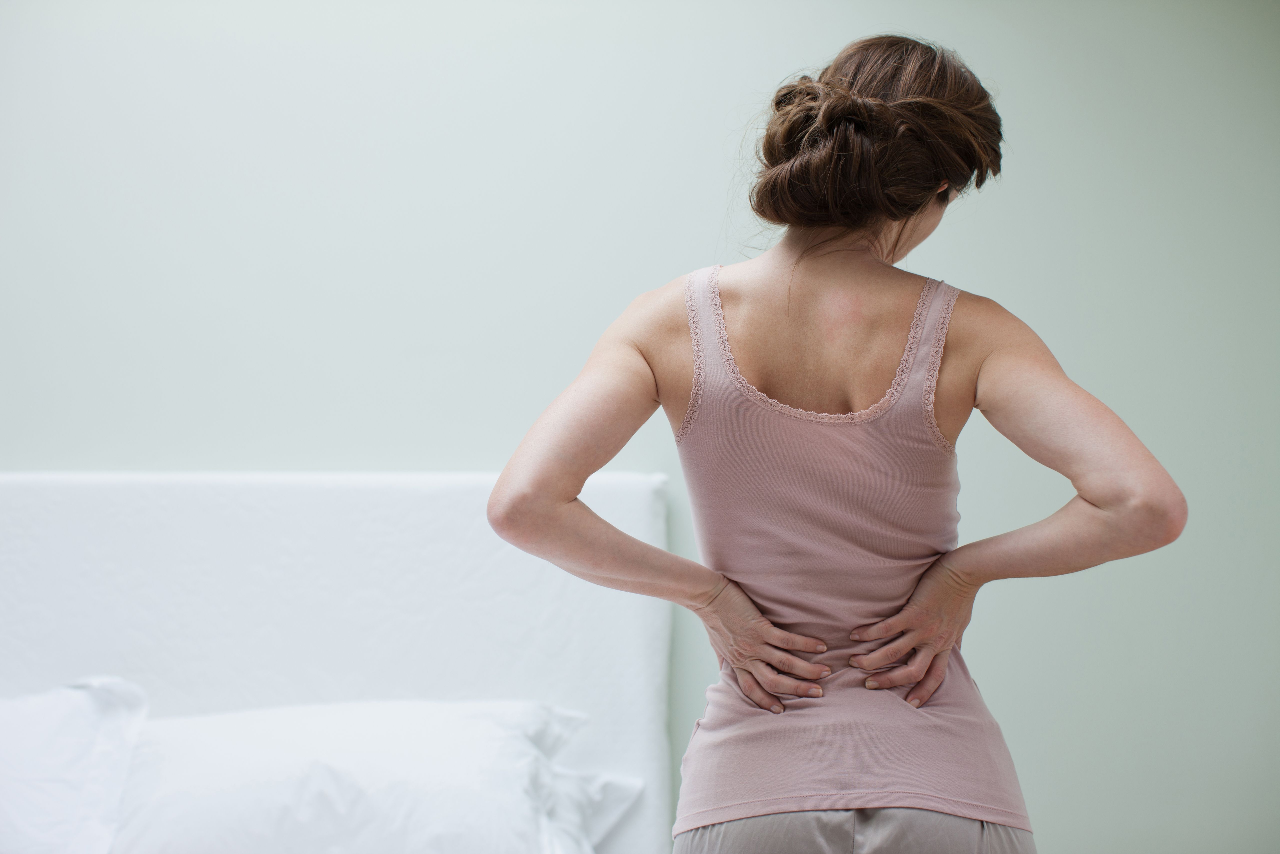 Female holding back in pain