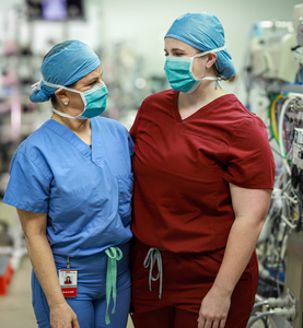 Dr. Guleserian and Laney pose in scrubs