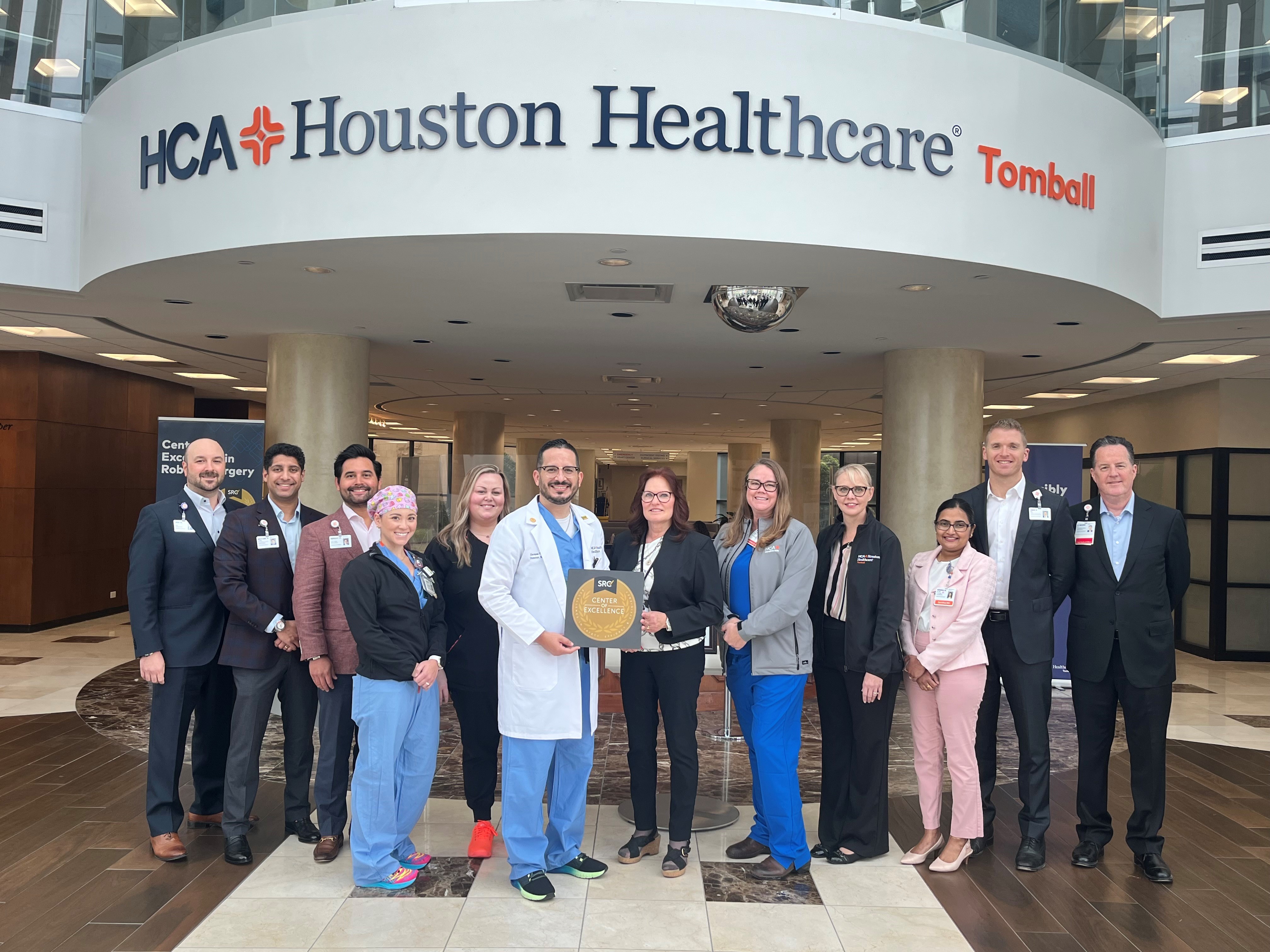 HCA Houston Healthcare Tomball team holding their Center of Excellence award