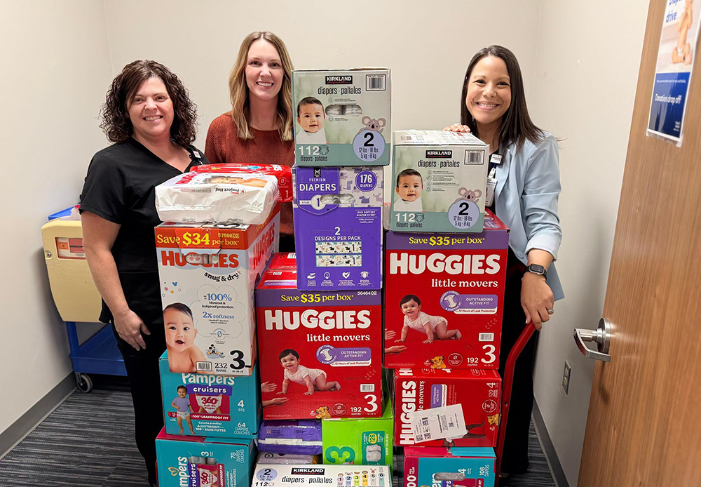 HCA Team members pose with diaper donations.