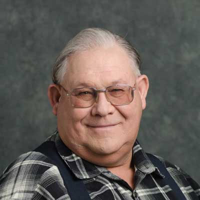 Monty smiles for the camera, against a gray backdrop.