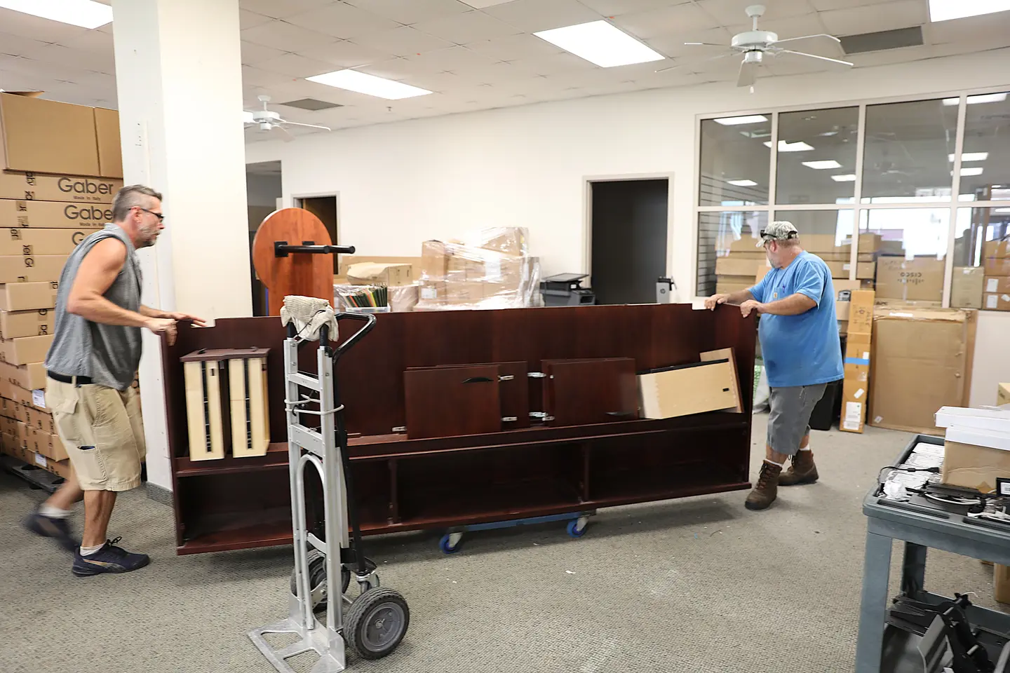 Furniture being moved off a truck.