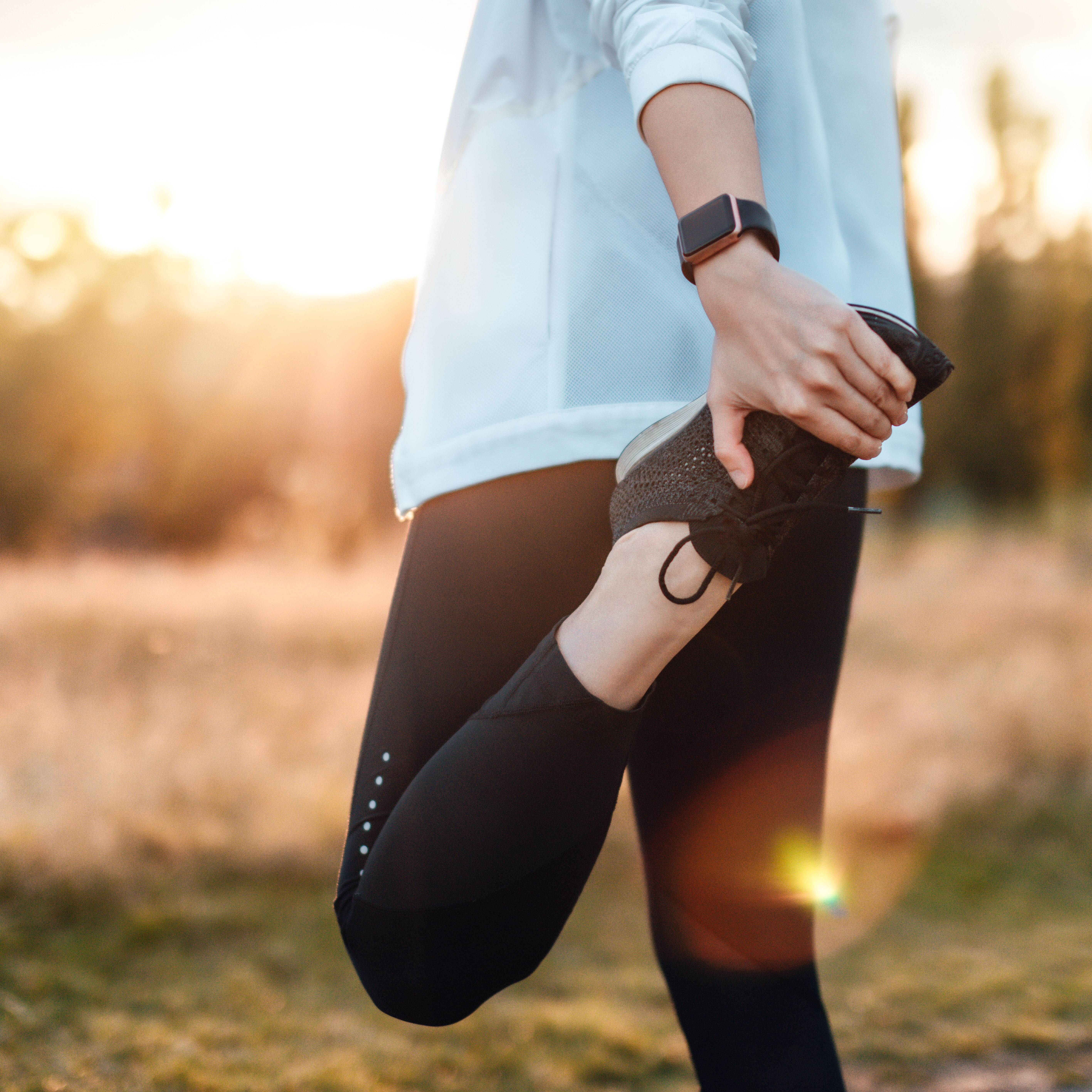 Woman doing standing quadricep stretch.
