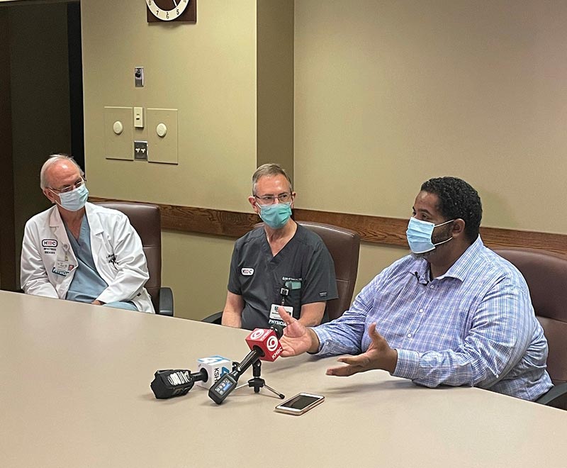 Antwaun Dunnigan answers questions with hospital staff.