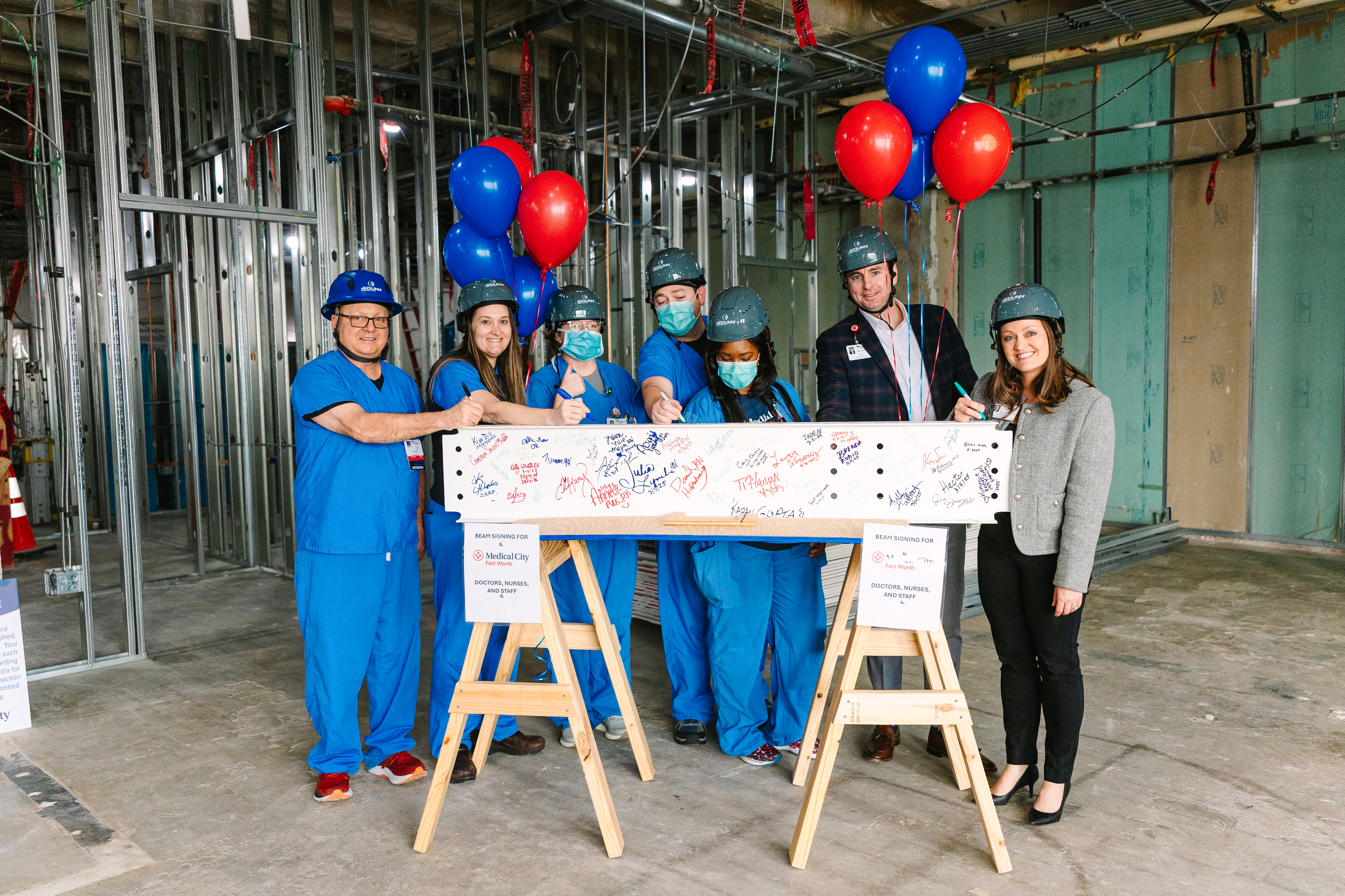 Photo of team members signing the beam.