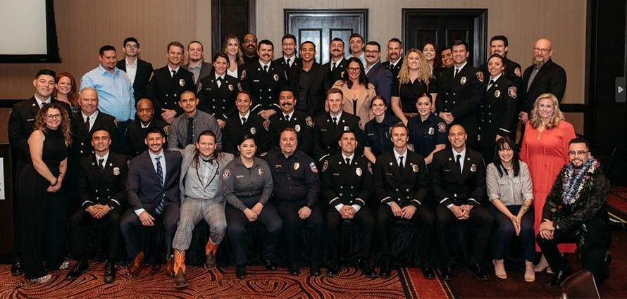 The large group of 2024 paramedic graduates have come together for a celebratory photo.