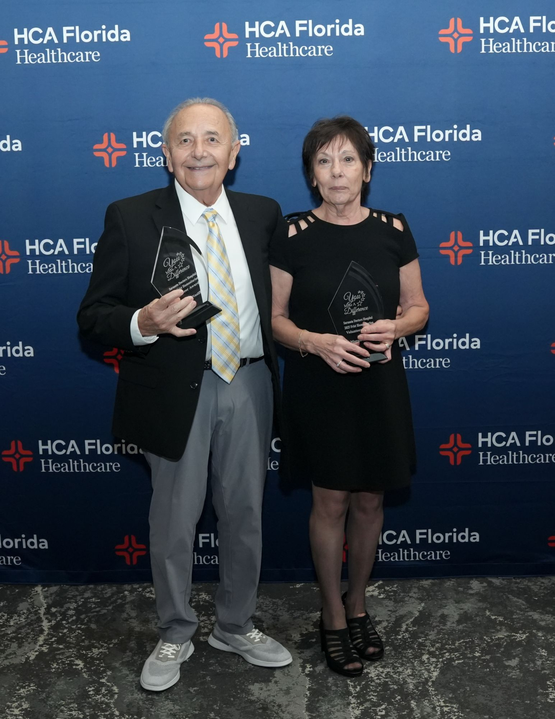 Richard and Margie Nasiff stand smiling with awards in hand