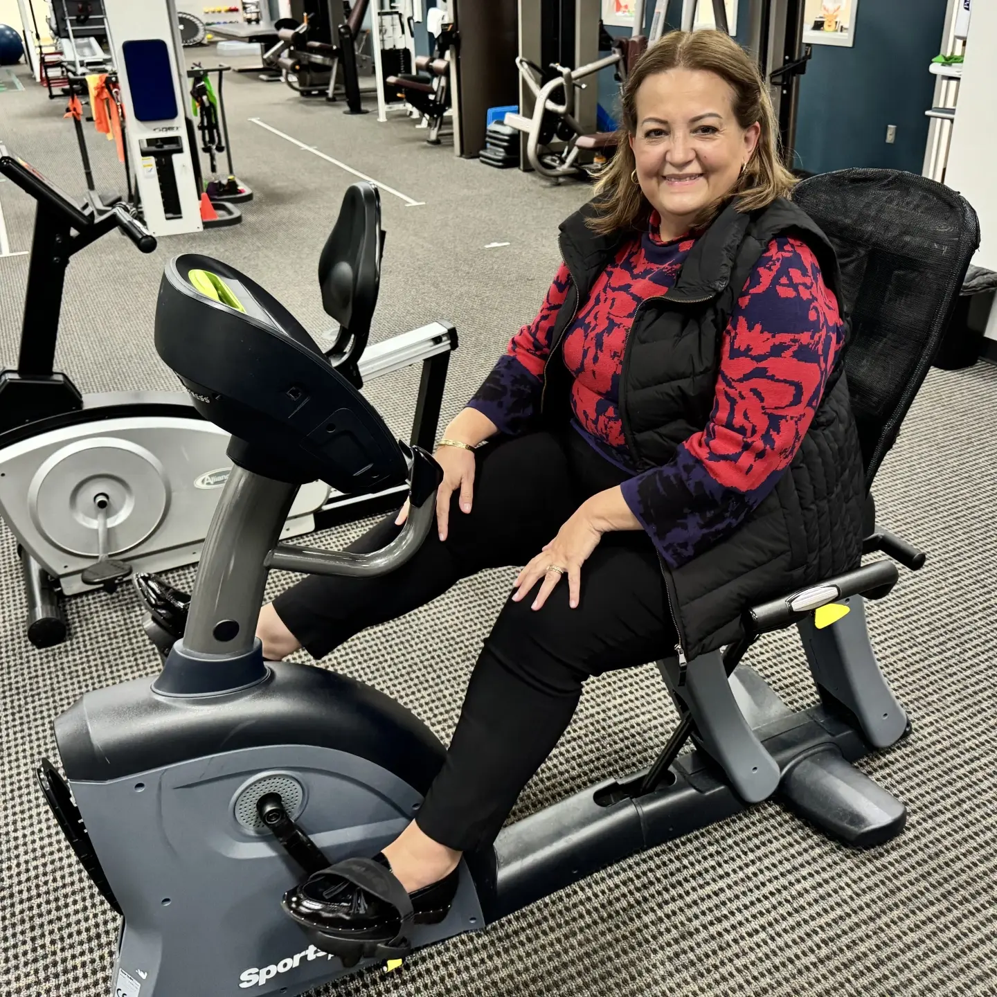 Woman using an exercise bike at Medical City Las Colinas for physical therapy.