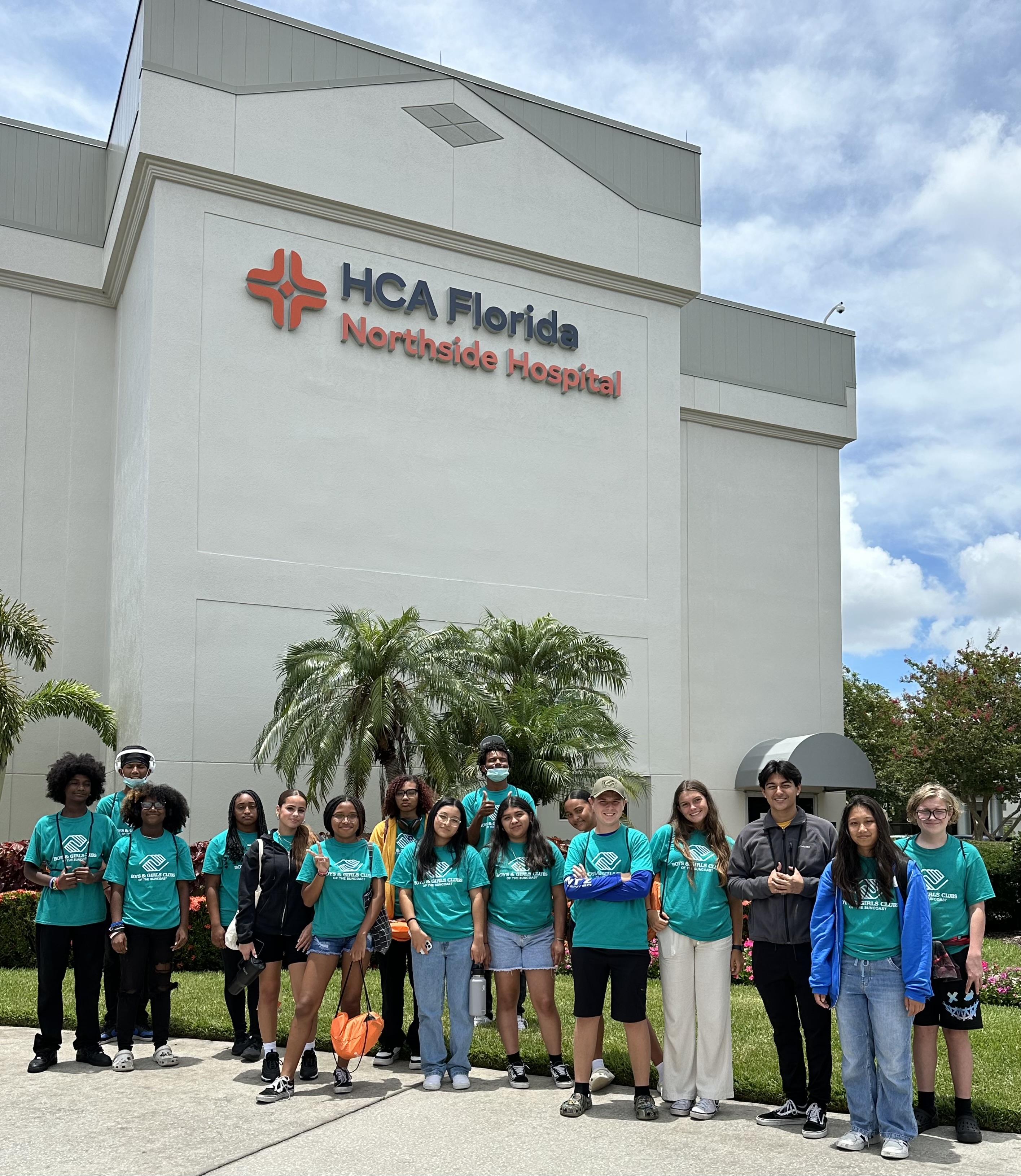 group of teenagers standing in front of hospital