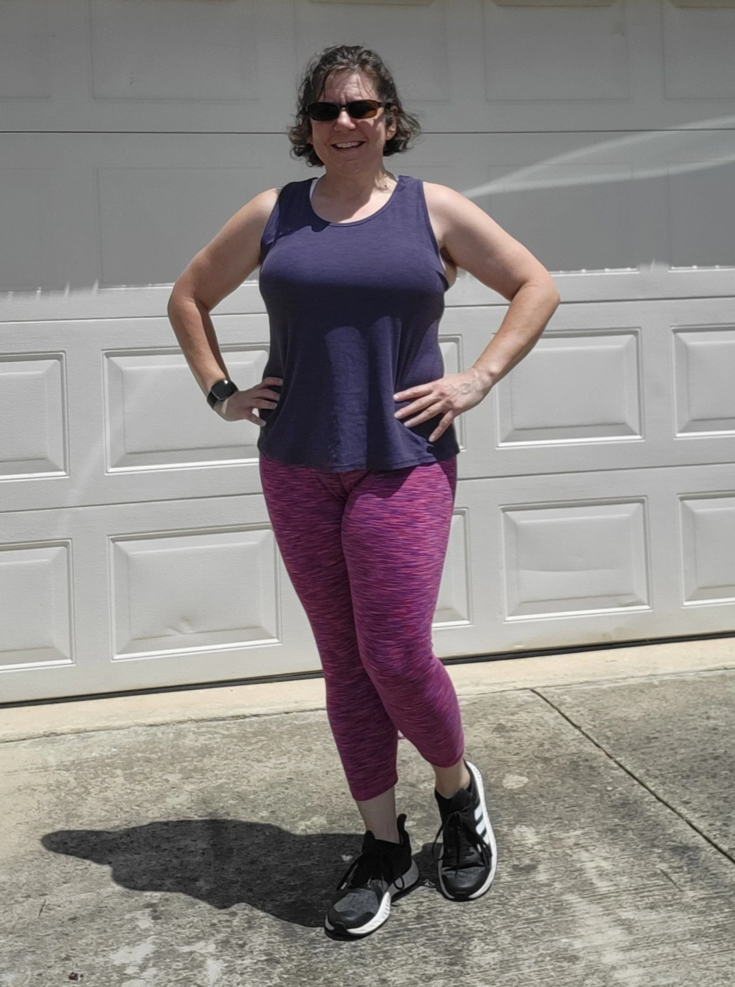 Heather posing near a garage door