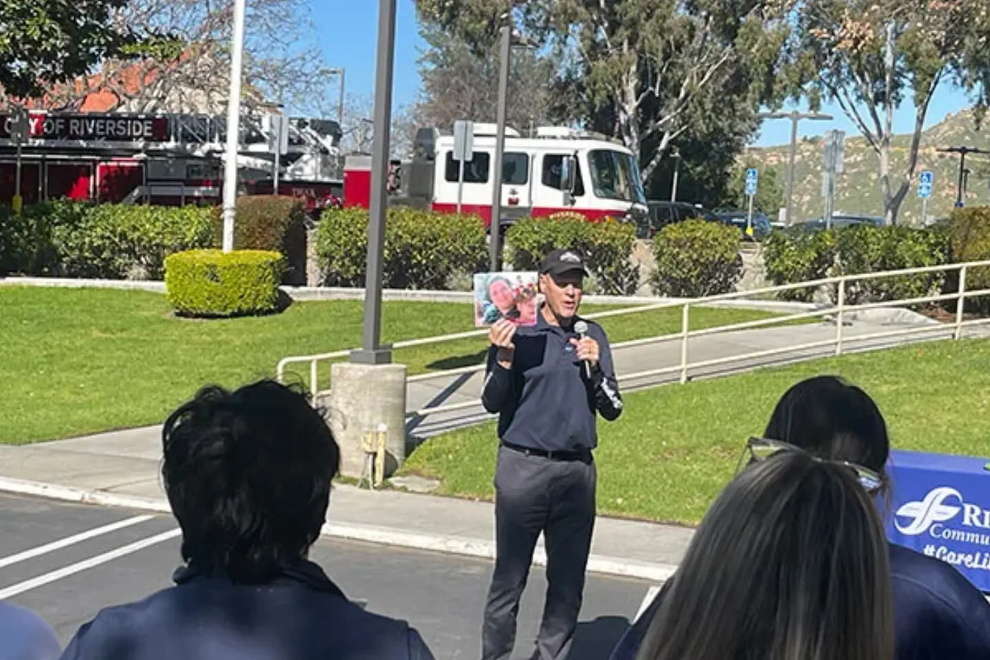 John Whalen holds a picture of the donor who John received his liver from while talking to the crowd during the annual Donate Life Flag Raising ceremony.