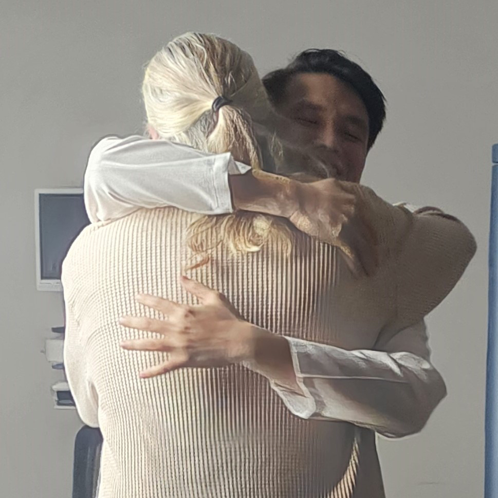 Dr. Tran and Bruce Hill hugging