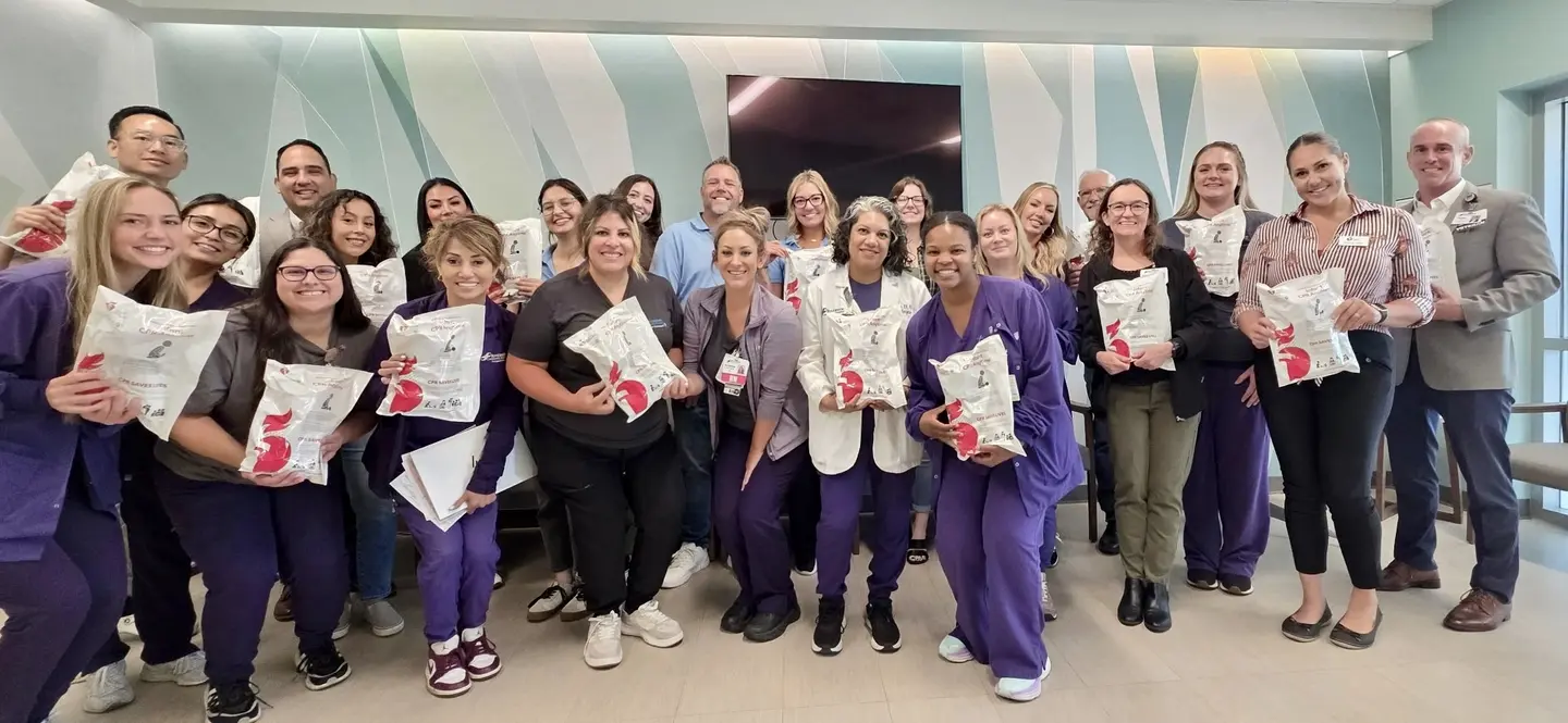 The RCH, PSR and AHA team posing for a group photo with the infant CPR kits