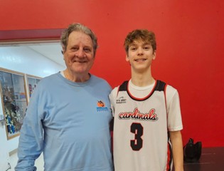 Robert and his grandson at his grandson's basketball game