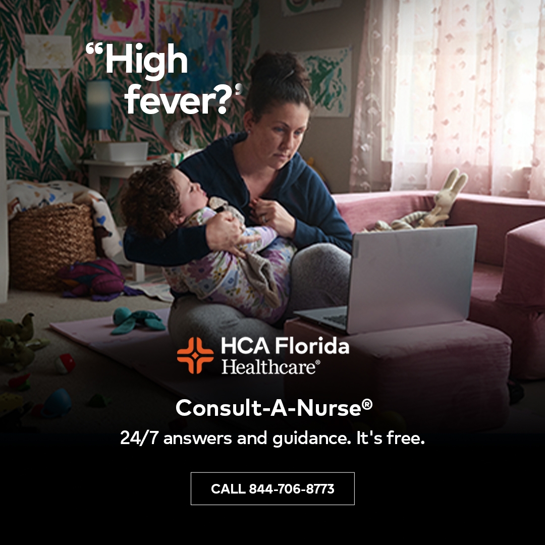 Woman with baby in front of lap top.