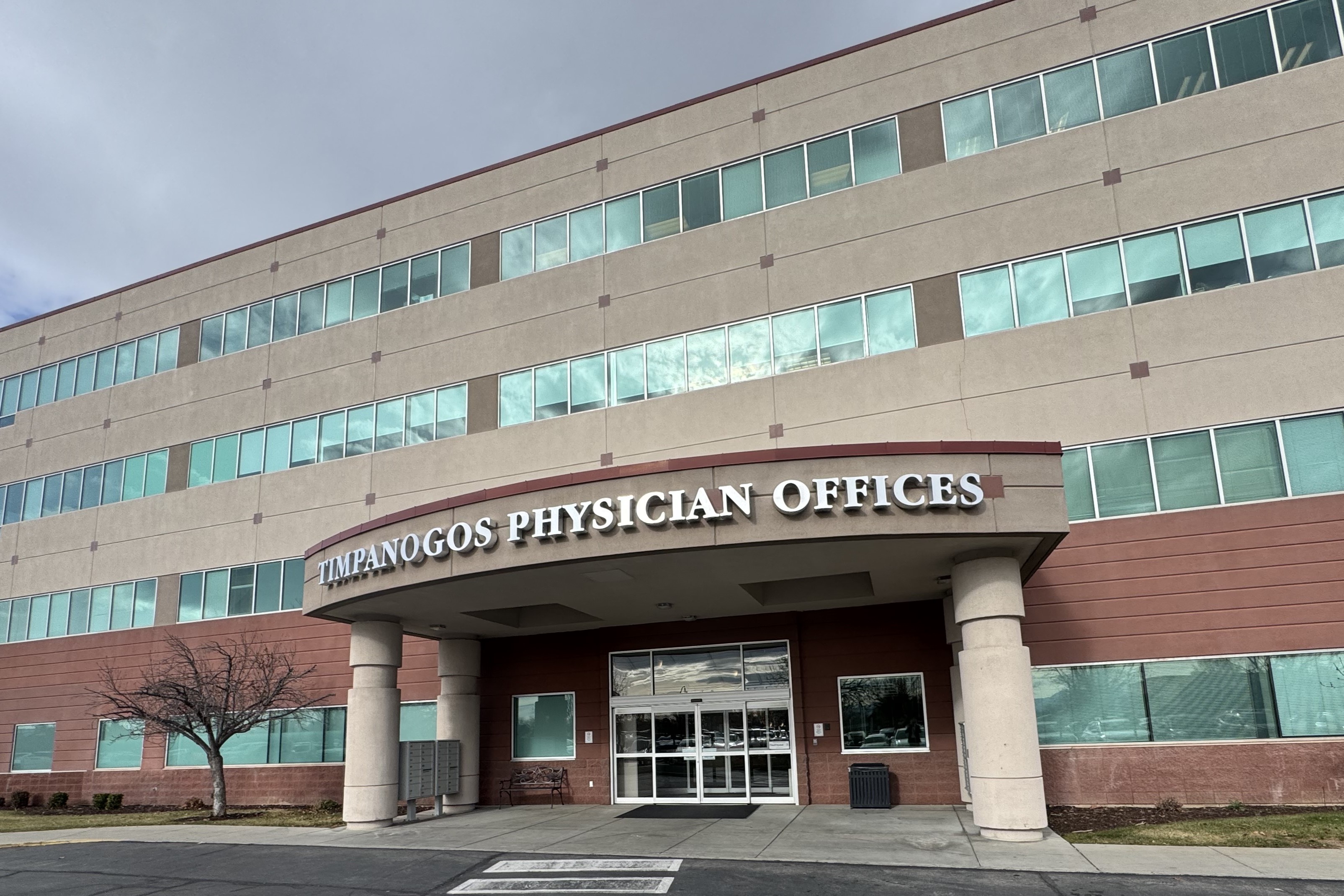 Timpanogos Physicians Offices front entrance, four story building with name aboce the front awning.